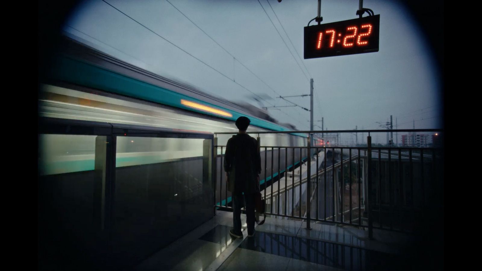 a man standing on a platform next to a train