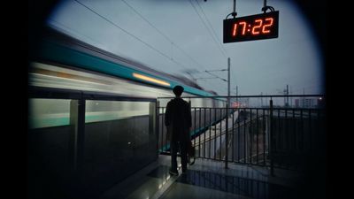 a man standing on a platform next to a train