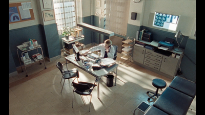 a man sitting at a desk in a room