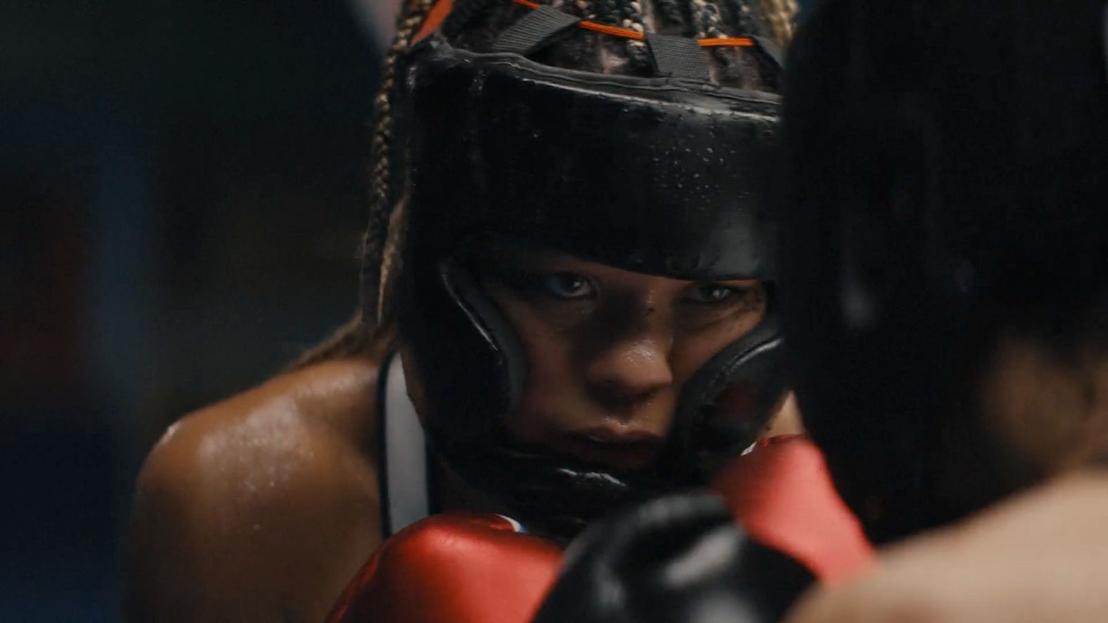 a close up of a person wearing boxing gloves