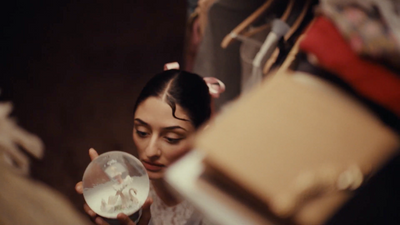 a woman holding a glass ball in front of her face