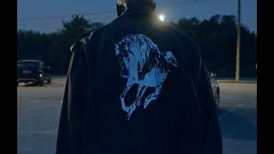 a man standing in a parking lot at night