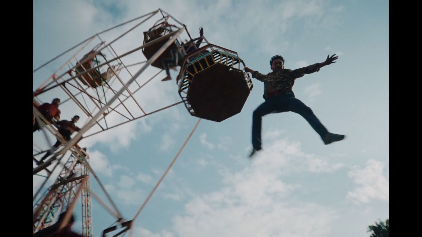 a man is falling off of a ferris wheel