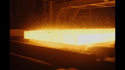 a piece of metal being cast in a factory