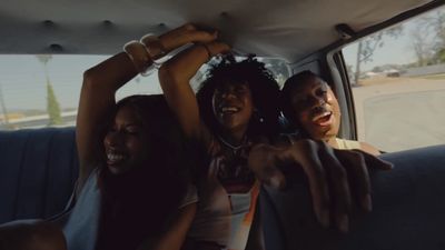 a group of people sitting in the back of a car