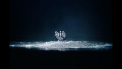 a person riding a wave in the ocean at night