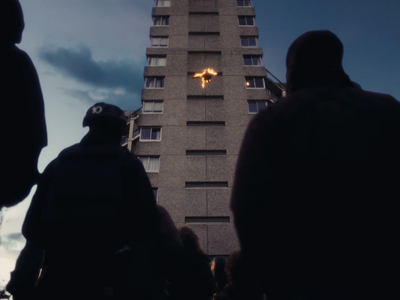 a group of people standing in front of a tall building