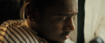 a close up of a person wearing a striped shirt