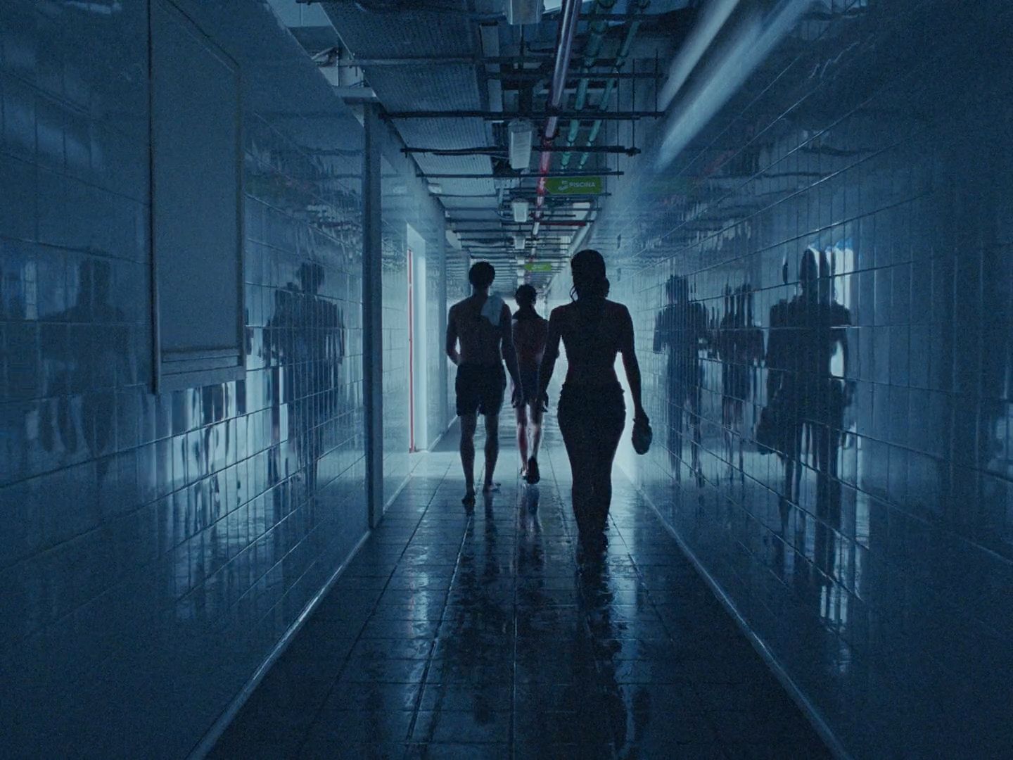 a group of people walking down a hallway