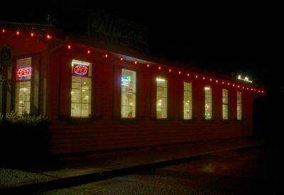 a red building with lit up windows at night