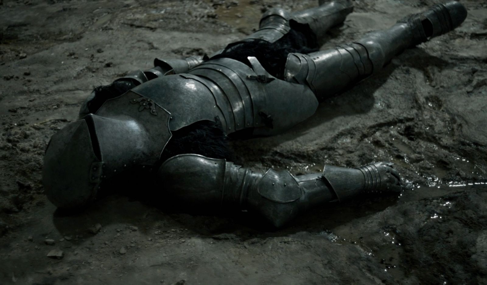 a man in armor laying on the ground