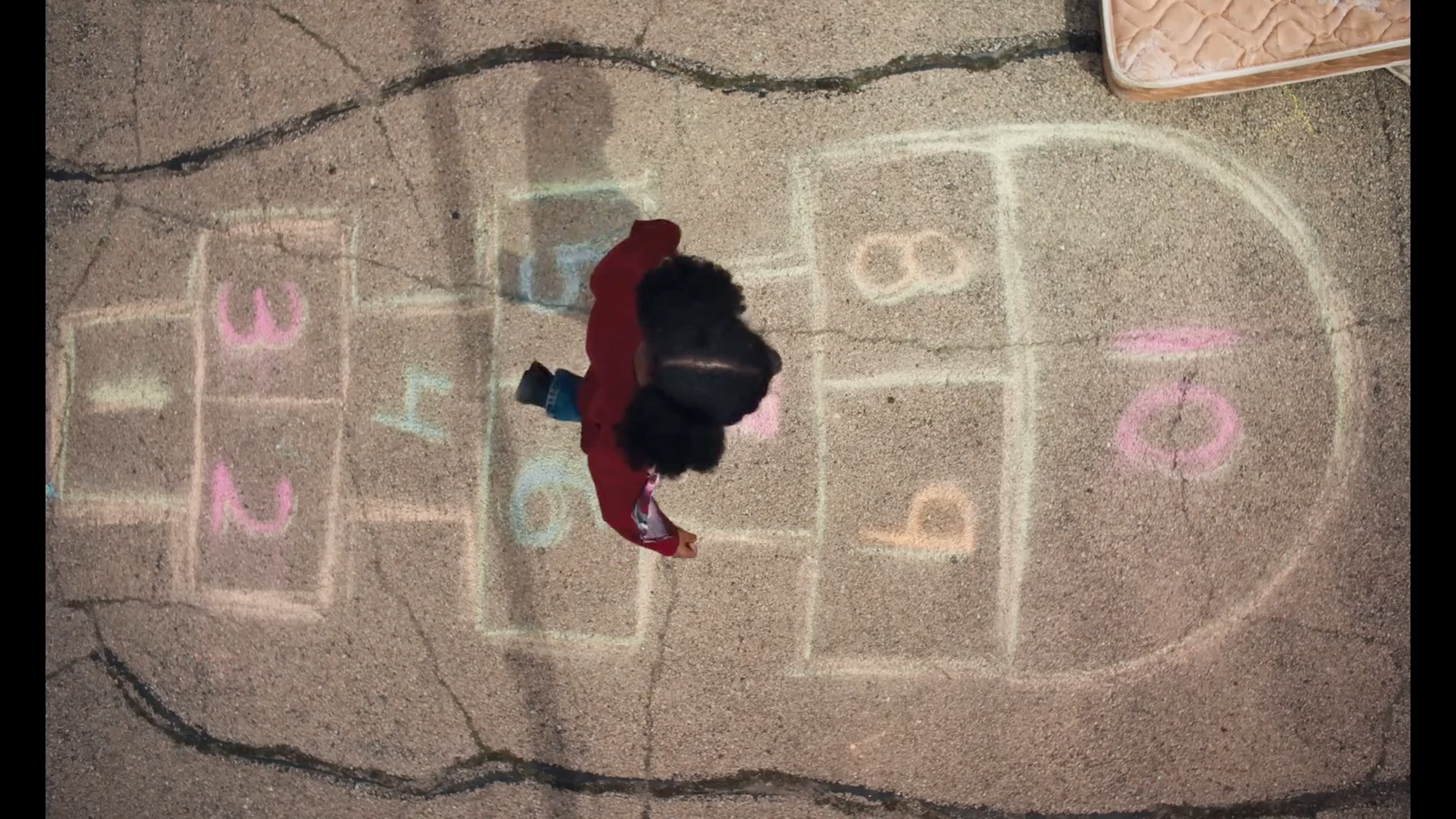 a person standing in front of a chalk drawing of a basketball court