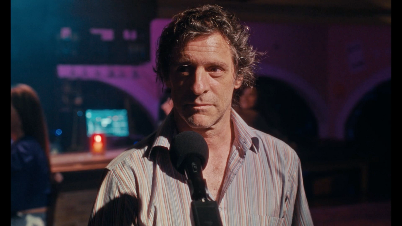 a man standing in front of a microphone