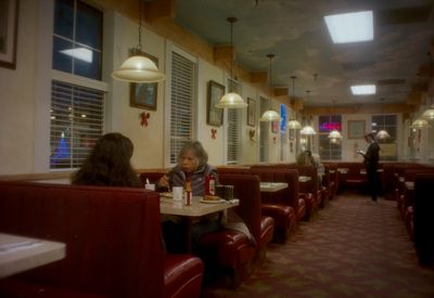 a woman sitting at a table in a restaurant