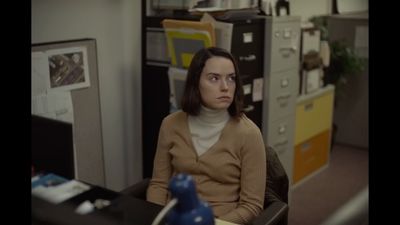 a woman sitting at a desk in an office