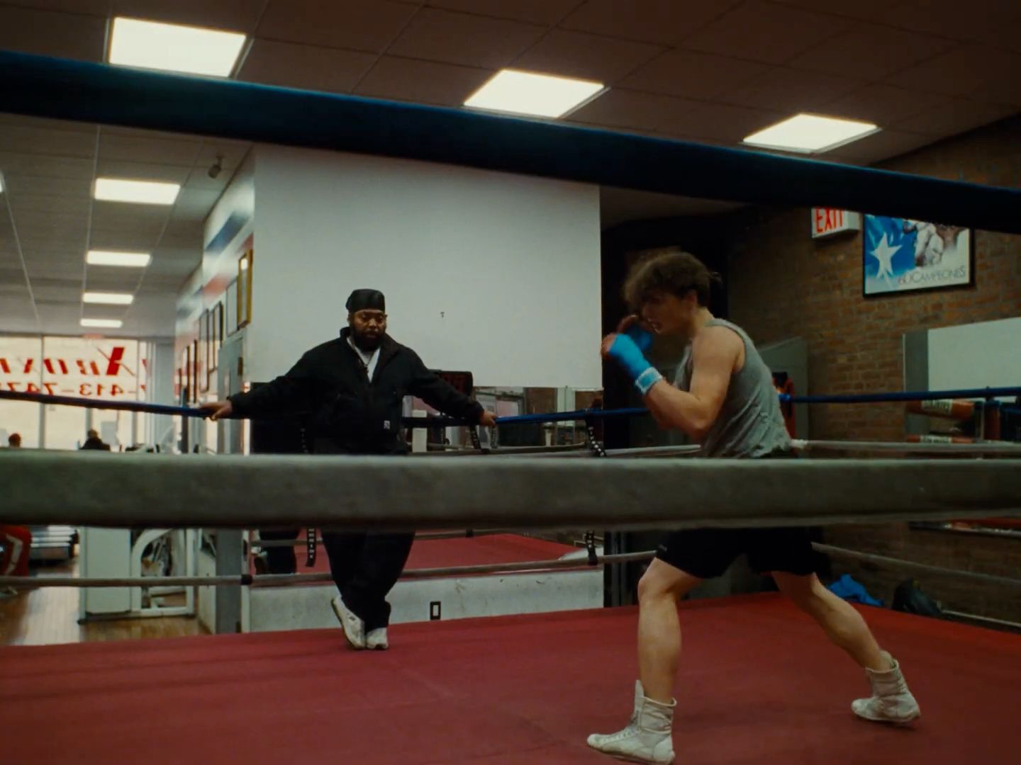 a man standing next to a boxing ring