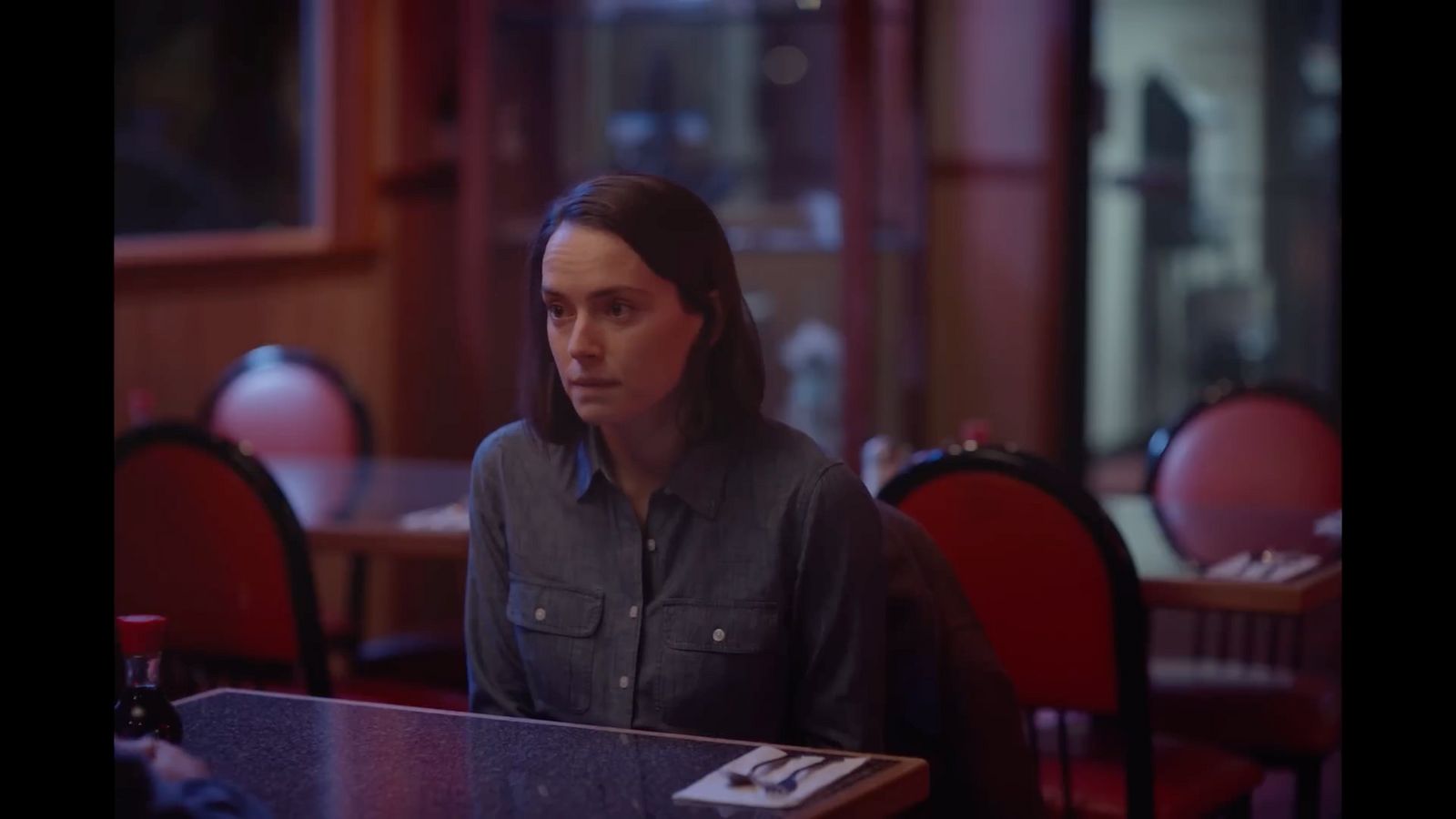 a woman sitting at a table in a restaurant