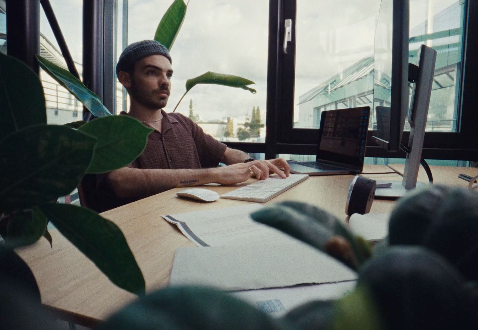 a man sitting at a desk in front of a computer