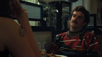 a man sitting at a table with a plate of food in front of him