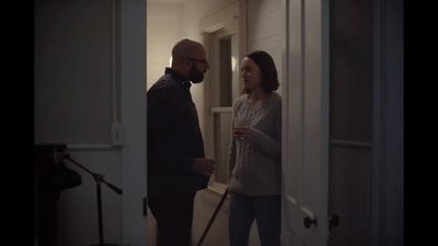 a man standing next to a woman in a hallway