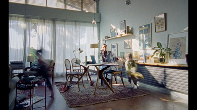 a man sitting at a table in a living room