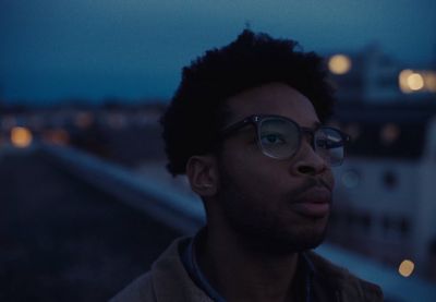 a man with glasses looking off into the distance