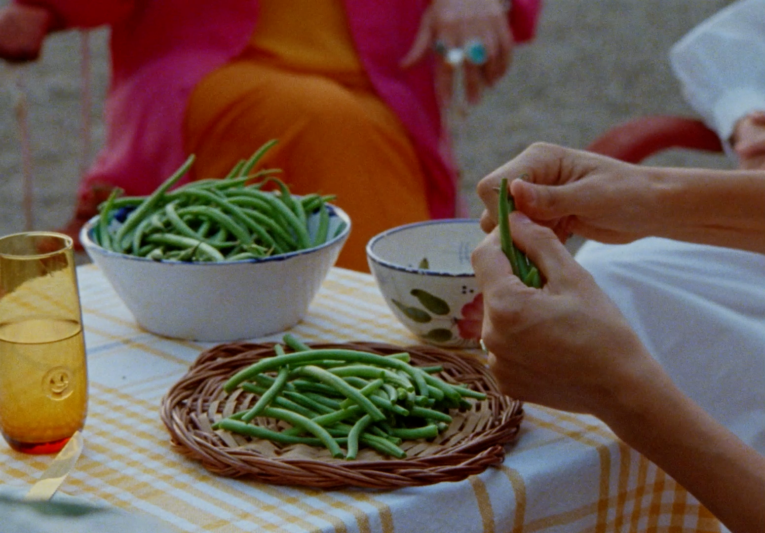 a table topped with bowls of green beans