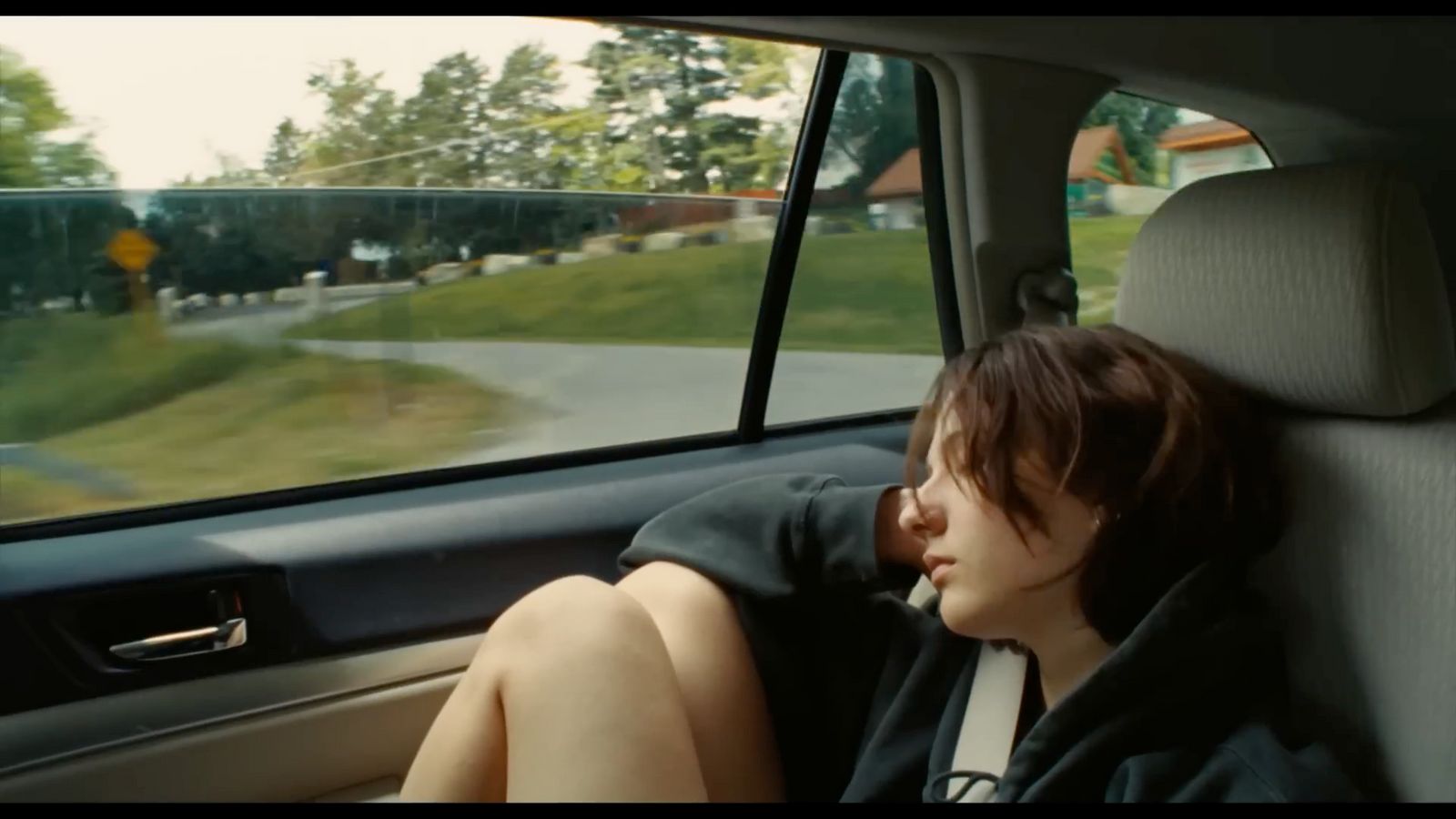 a woman sitting in the back seat of a car