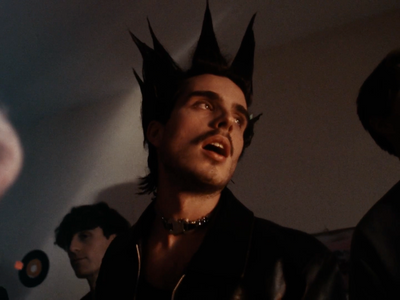 a man with spiked hair standing in a room