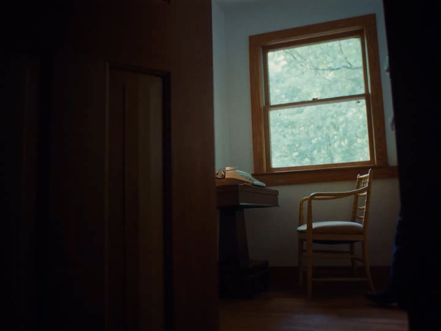 a chair sitting in front of a window in a room