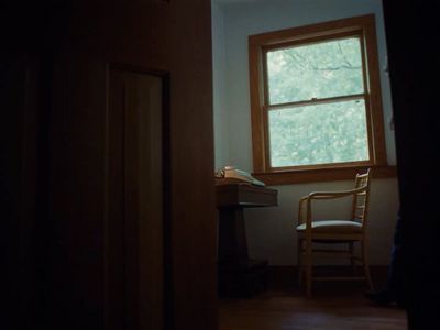 a chair sitting in front of a window in a room