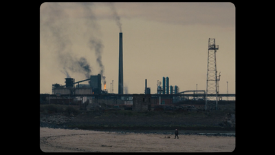 a factory with smoke pouring out of it's stacks