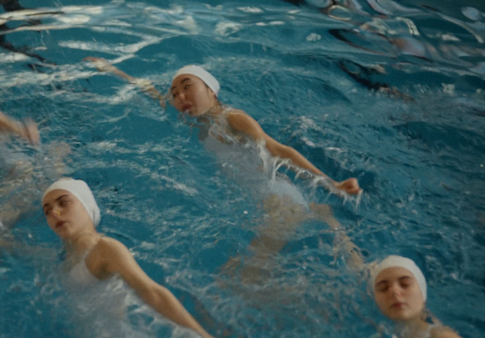 a group of people swimming in a pool