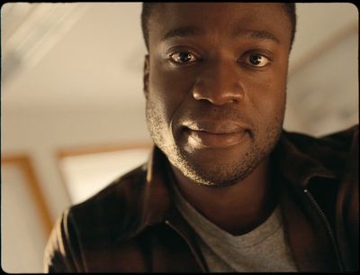 a close up of a person wearing a leather jacket