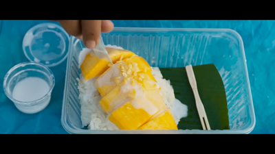 a plastic container filled with rice and fruit