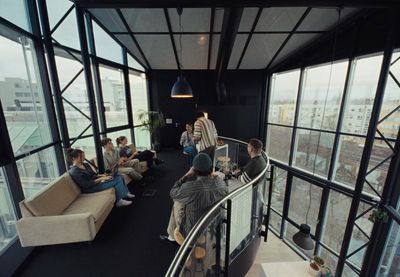 a group of people sitting on top of a balcony