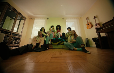 a group of people sitting on top of a green couch