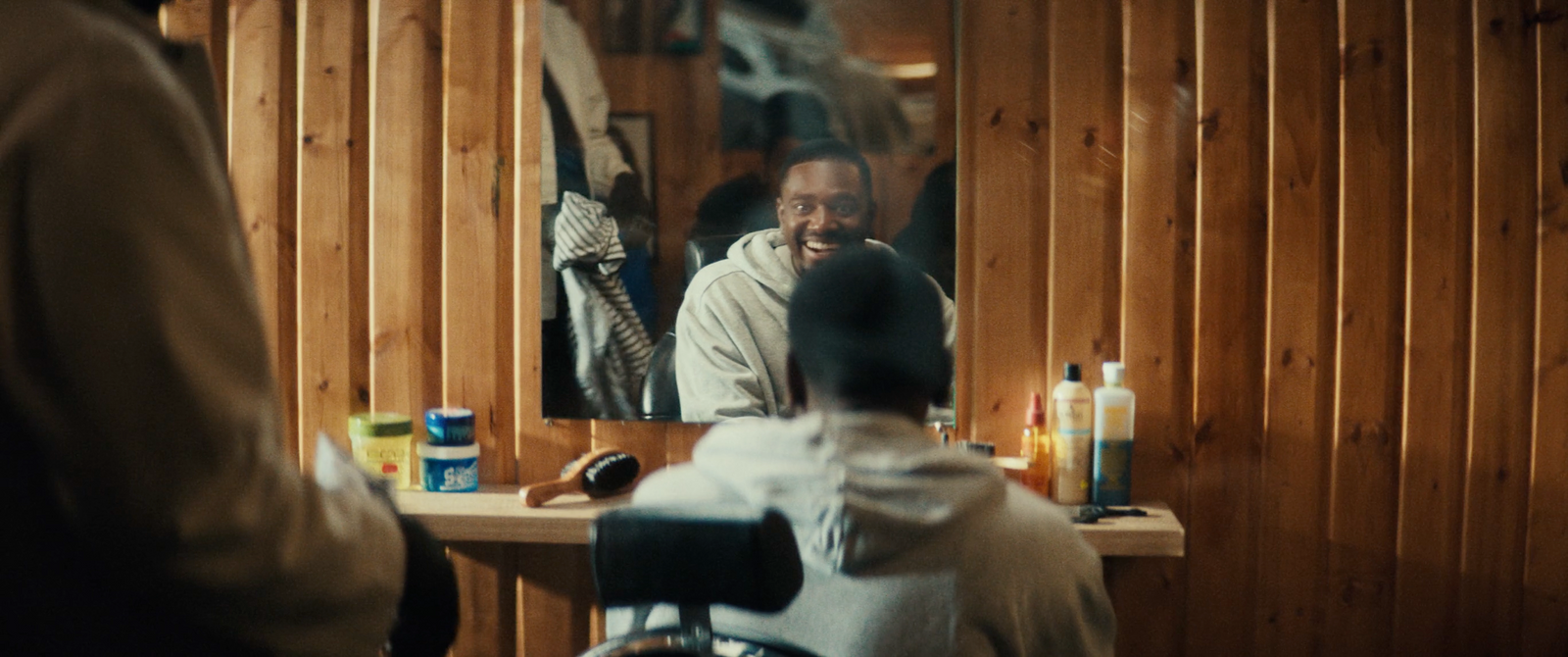 a man sitting in a chair in front of a mirror