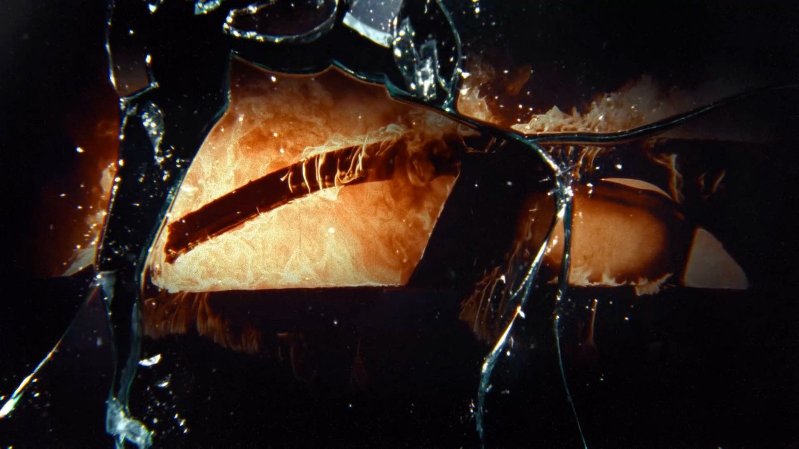 a close up of a piece of food in a broken glass