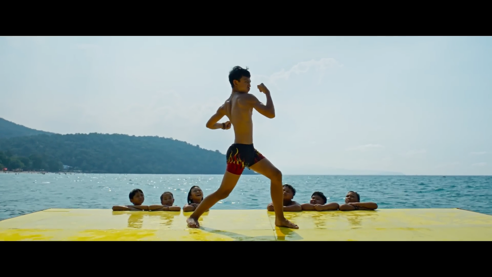 a man running on a yellow raft in the water