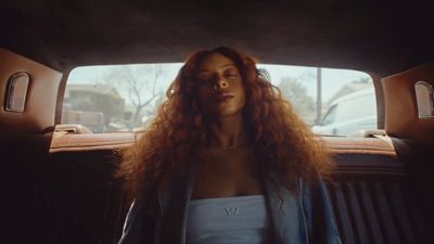 a woman sitting in the back of a car