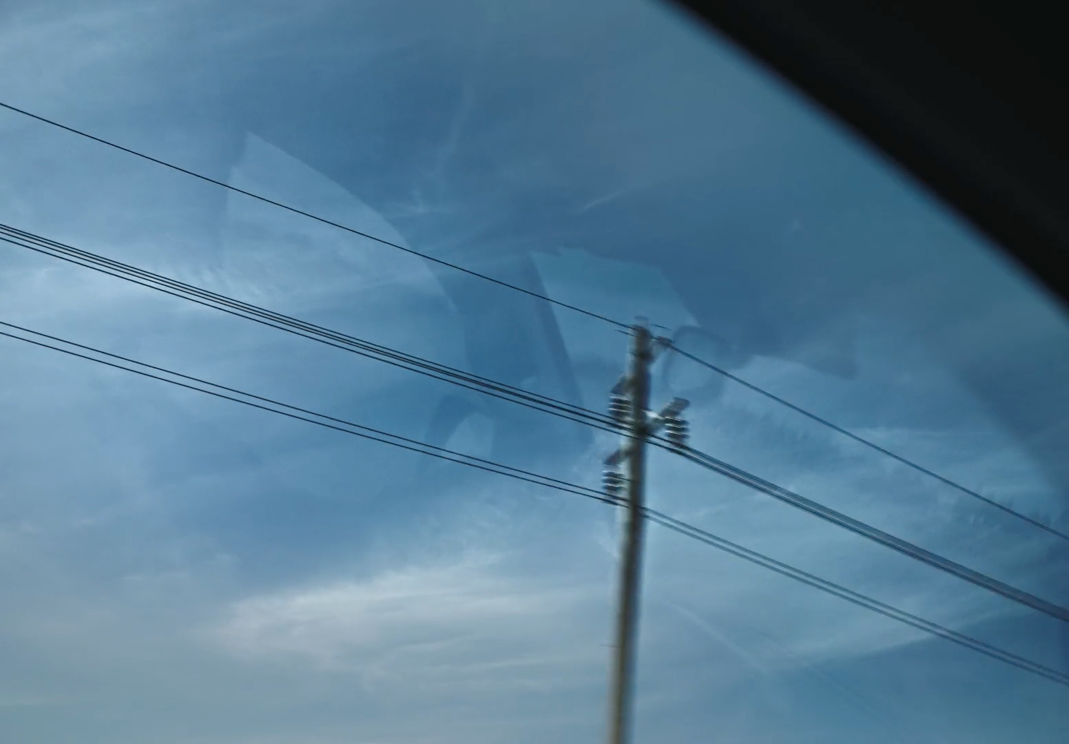 a view of power lines through a car window