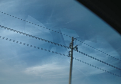 a view of power lines through a car window