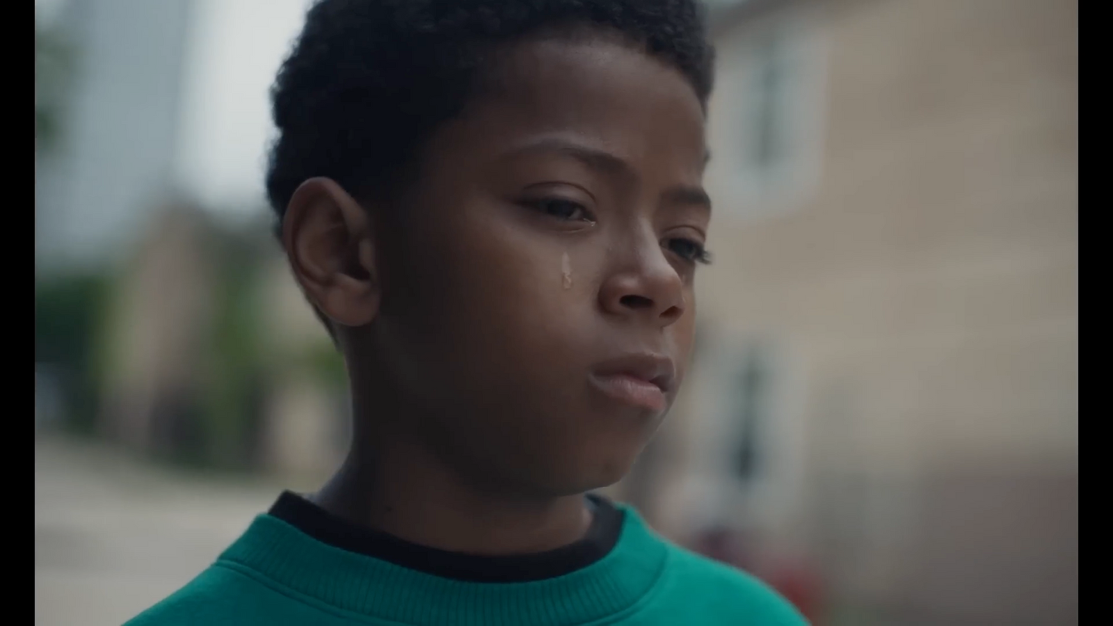 a close up of a person wearing a green shirt