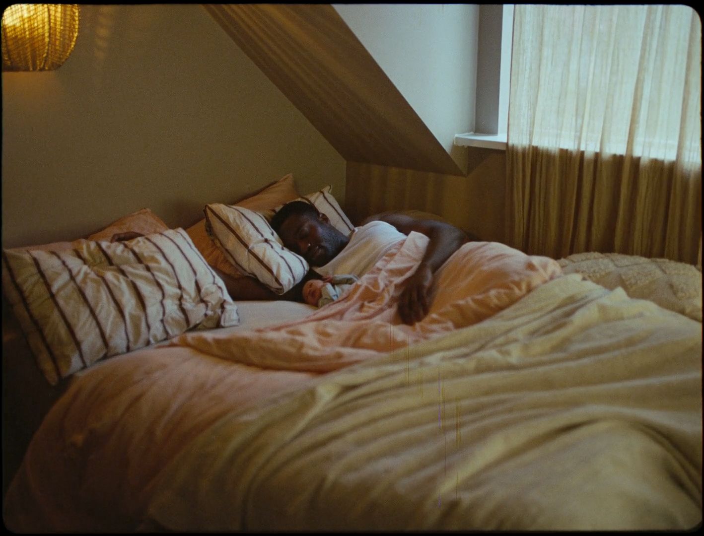 a person laying in a bed with pillows