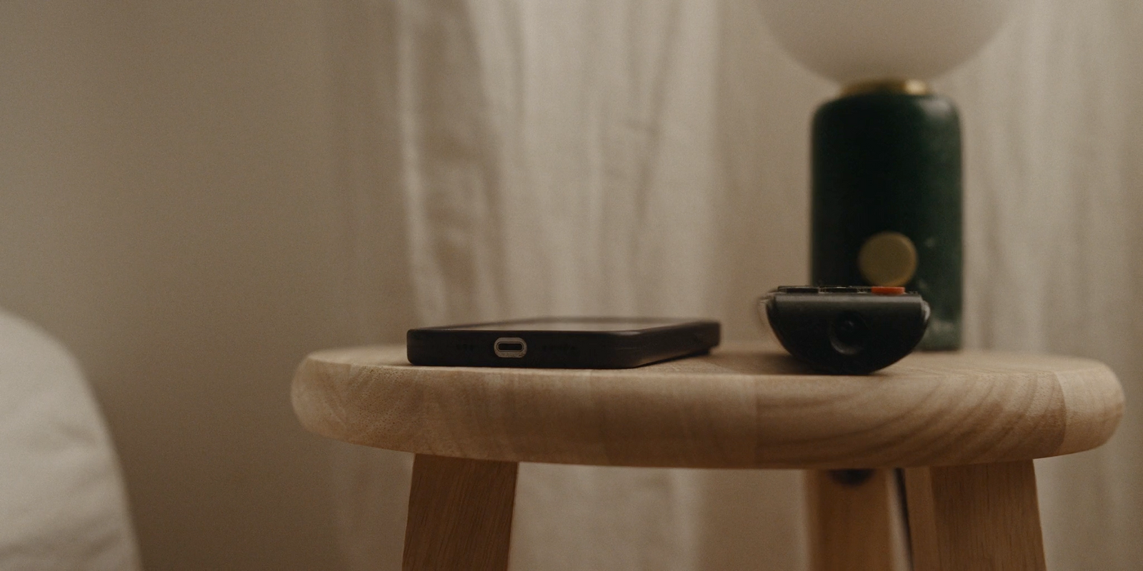 a cell phone sitting on top of a wooden table