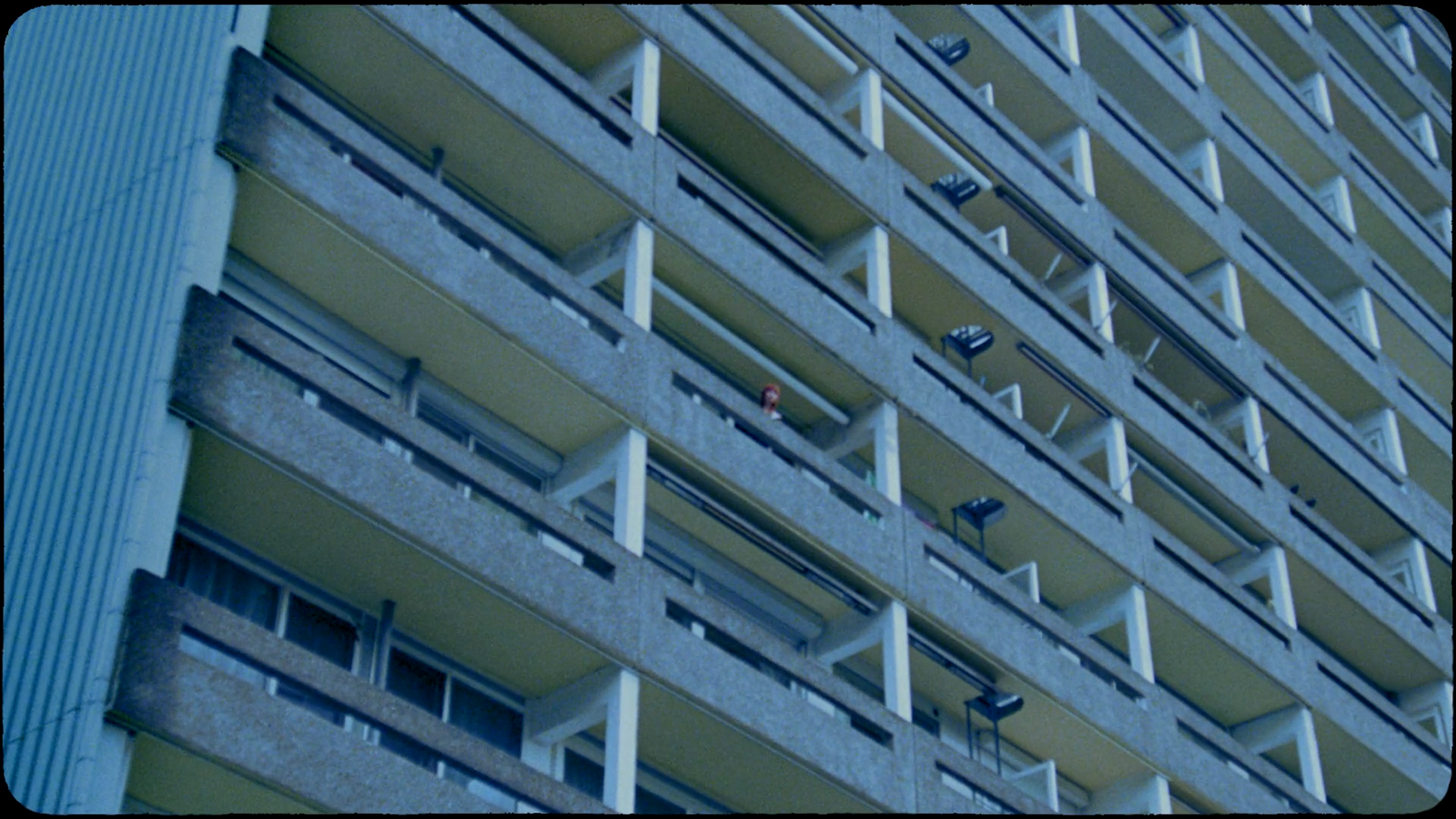 a very tall building with many balconies on it