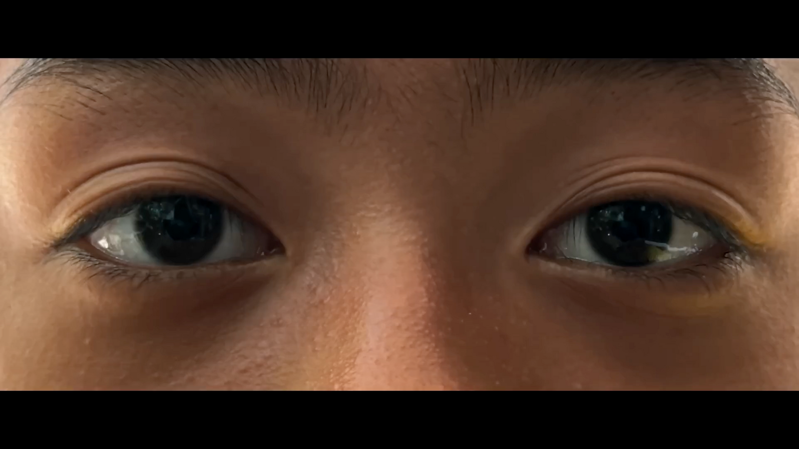 a close up of a person's eyes with brown eyes