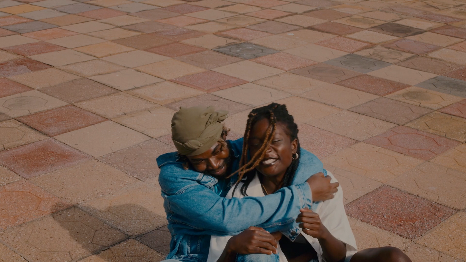 a couple of people that are sitting on the ground