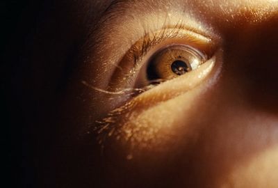 a close up of a person's eye with a blurry background